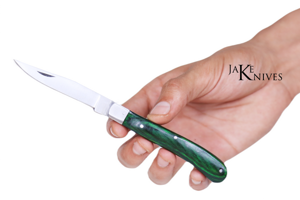 Folding knife with its green wood handle