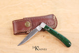 Folding knife with its green wood handle