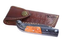 Folding knife with its black and brown wood handle