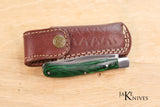 Folding knife with its green wood handle