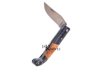 Folding knife with its black and brown wood handle