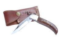 Folding knife with its dark brown wood made handle