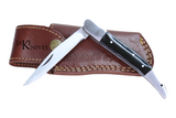 Folding knife with its black wood handle