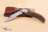 Folding knife with its dark brown wood made handle