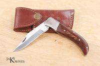 Folding knife with its dark brown wood made handle